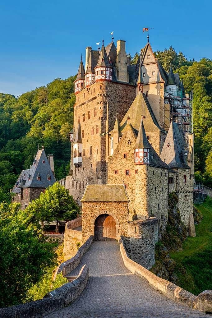 a castle with Eltz Castle and trees